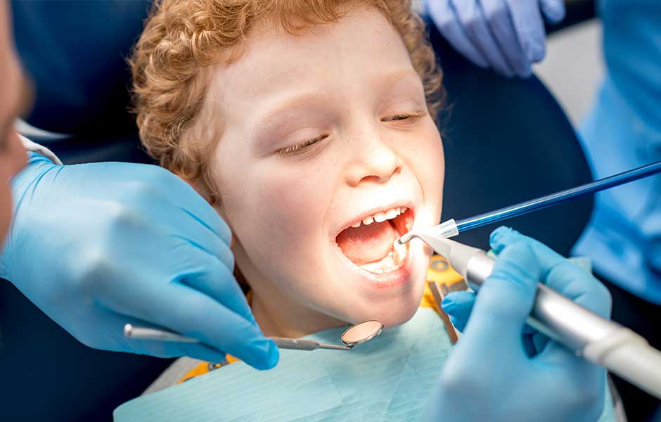 young child with mouth open during dental visit