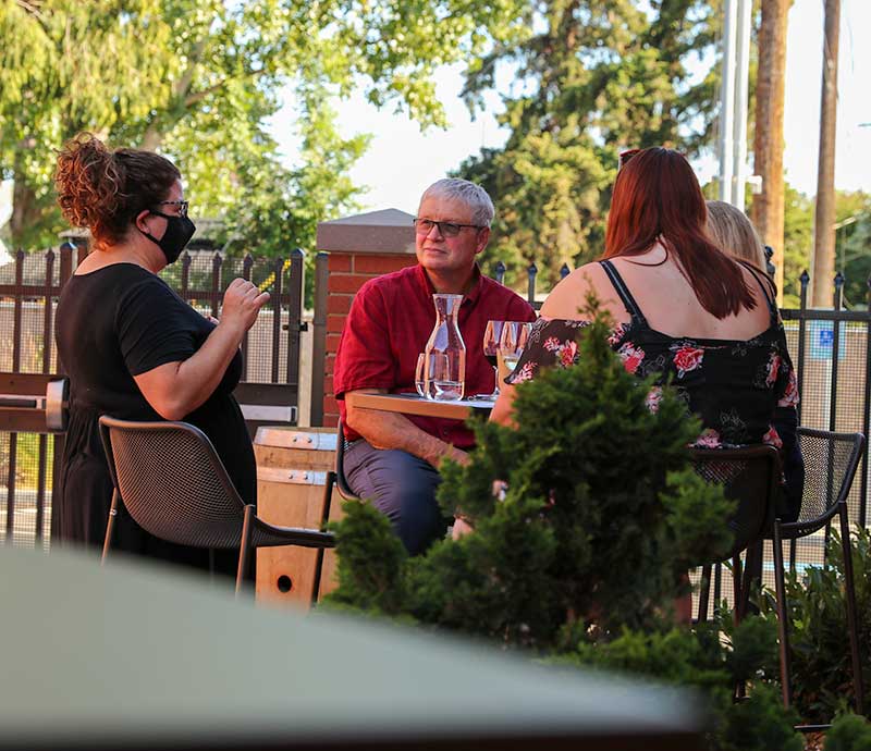 Annette Wattenberger speaks with customers at YVC's Yakima Tasting Room