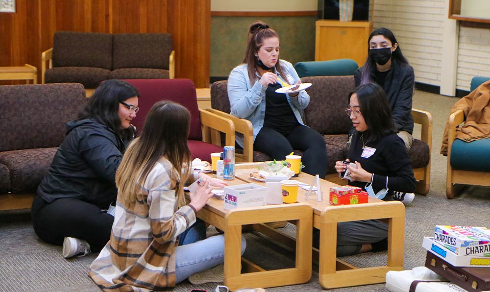 Students eat around a table