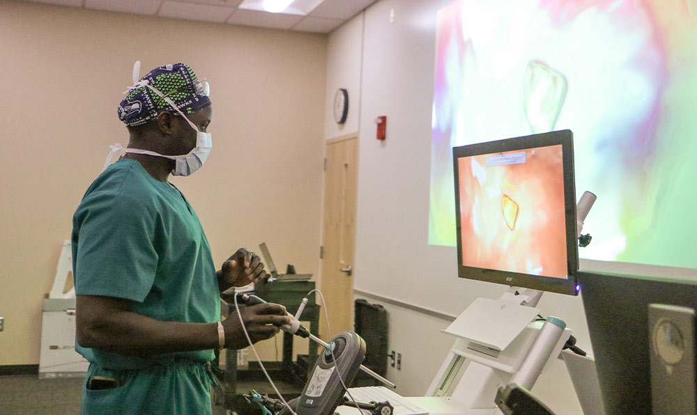 Surgical technology student practices with simulator