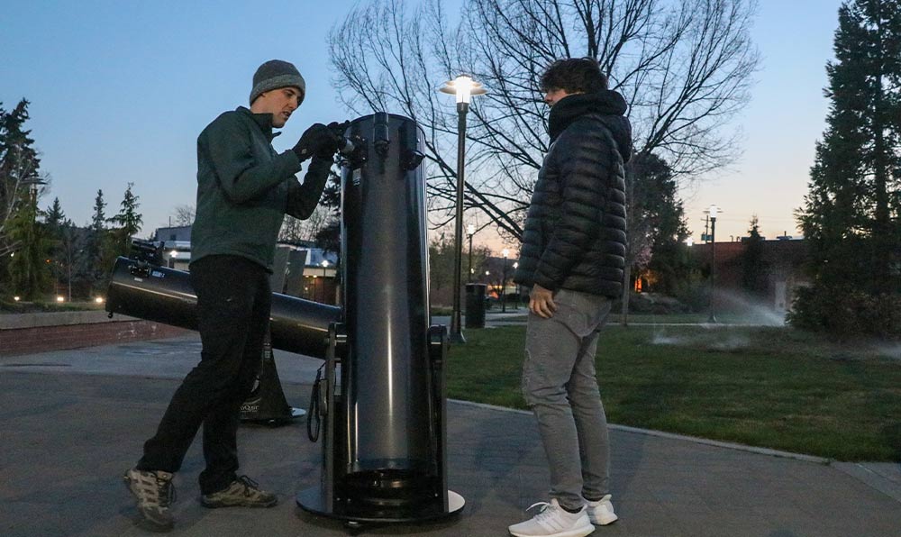 Instructor and student set up telescope