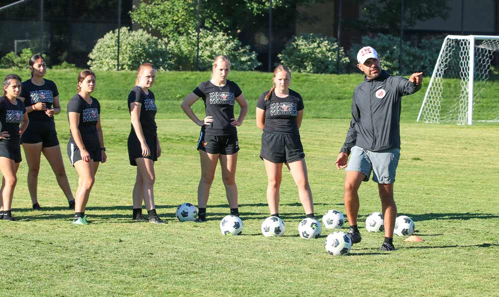 Coach with female soccer players