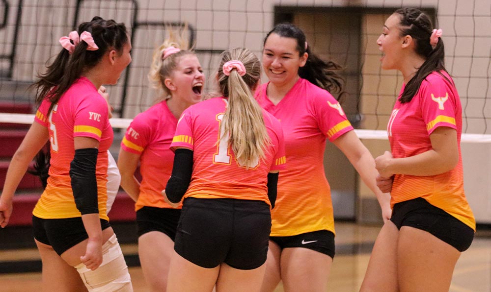 Female volleyball players celebrate