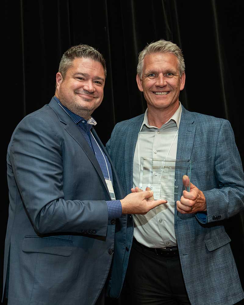 Mike Moe, left, presents the Outstanding Marketing Program award to Eric Patrick, director tourism for Union Gap, during the Oct. 11-12 State of Washington Tourism Conference.