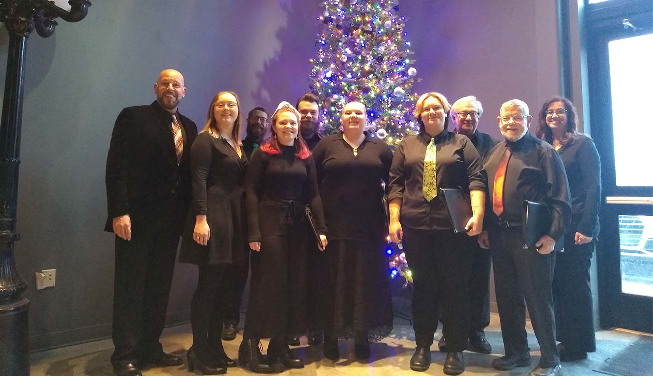 Singers in front of holiday tree