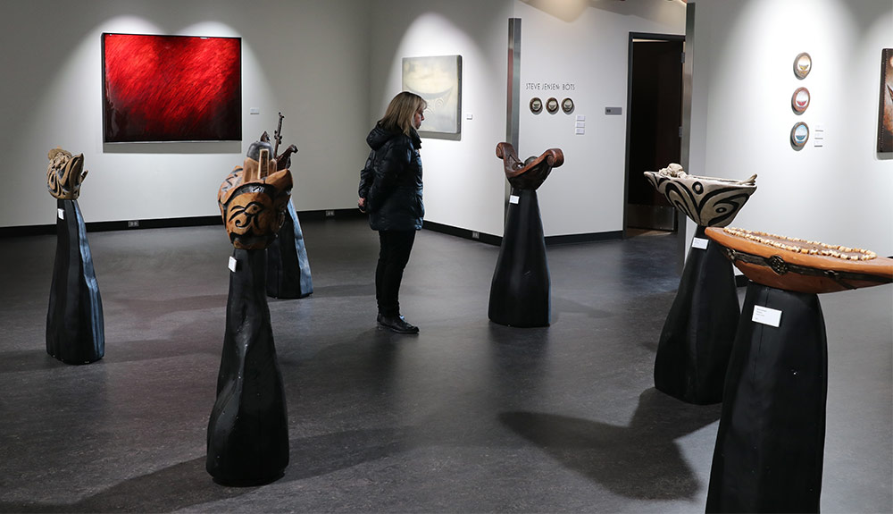 Woman views art in gallery