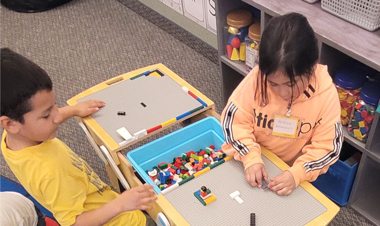 Students in Alicia Caballero's work with Lego's in class.