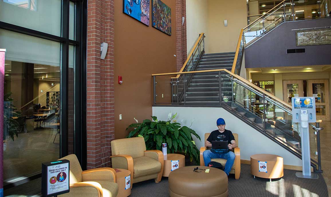 A student studies in Raymond Hall Library