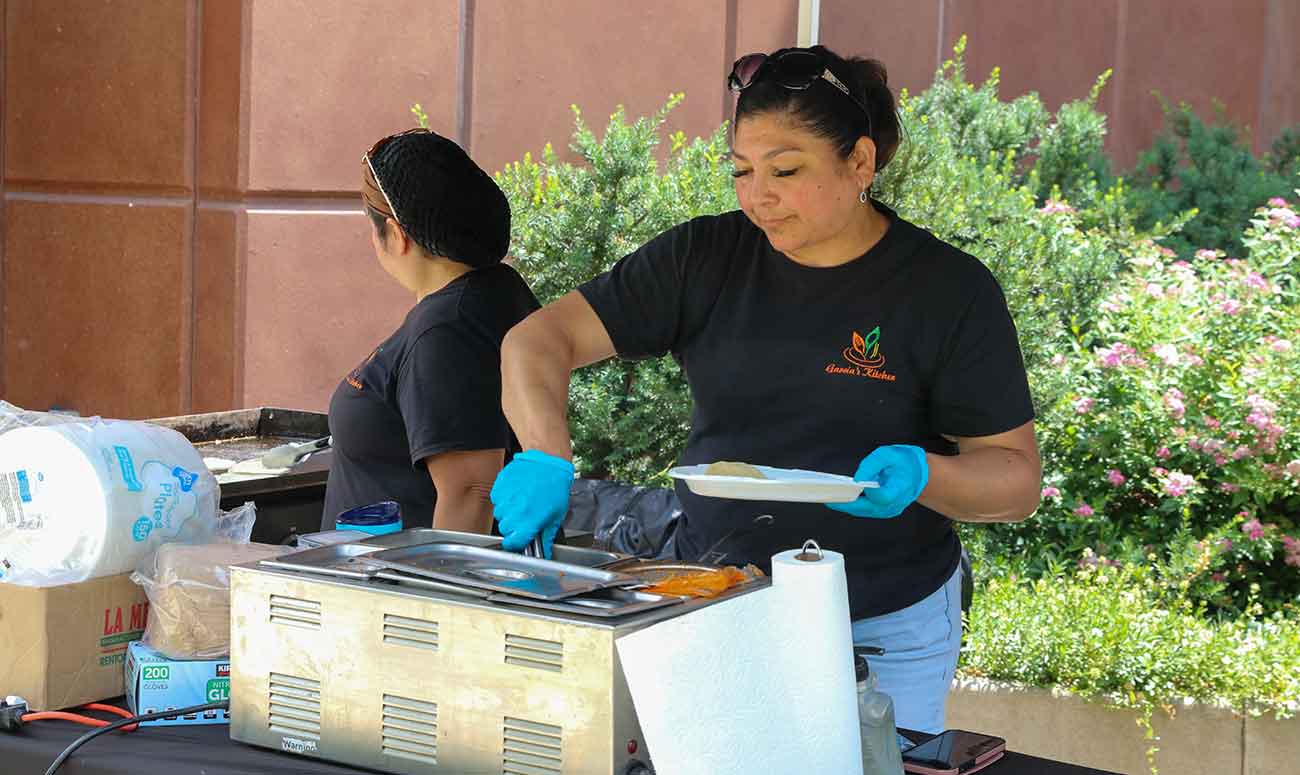 Ines Garcia serves food during YVC's Express Enrollment event