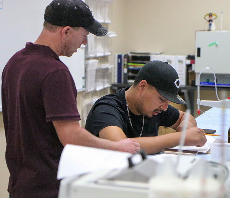 Trent ball works with a vineyard and winery technology student