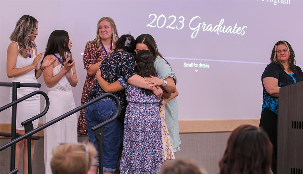 Student celebrates with family at pinning ceremony