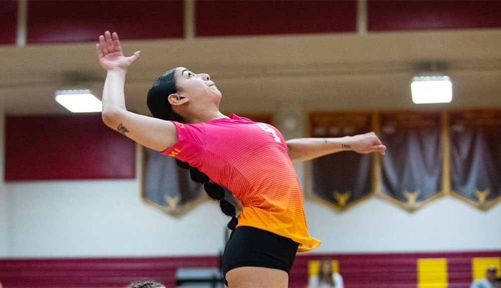 Female volleyball player prepares for spike