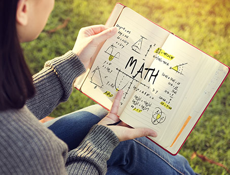 girl looking at math notebook