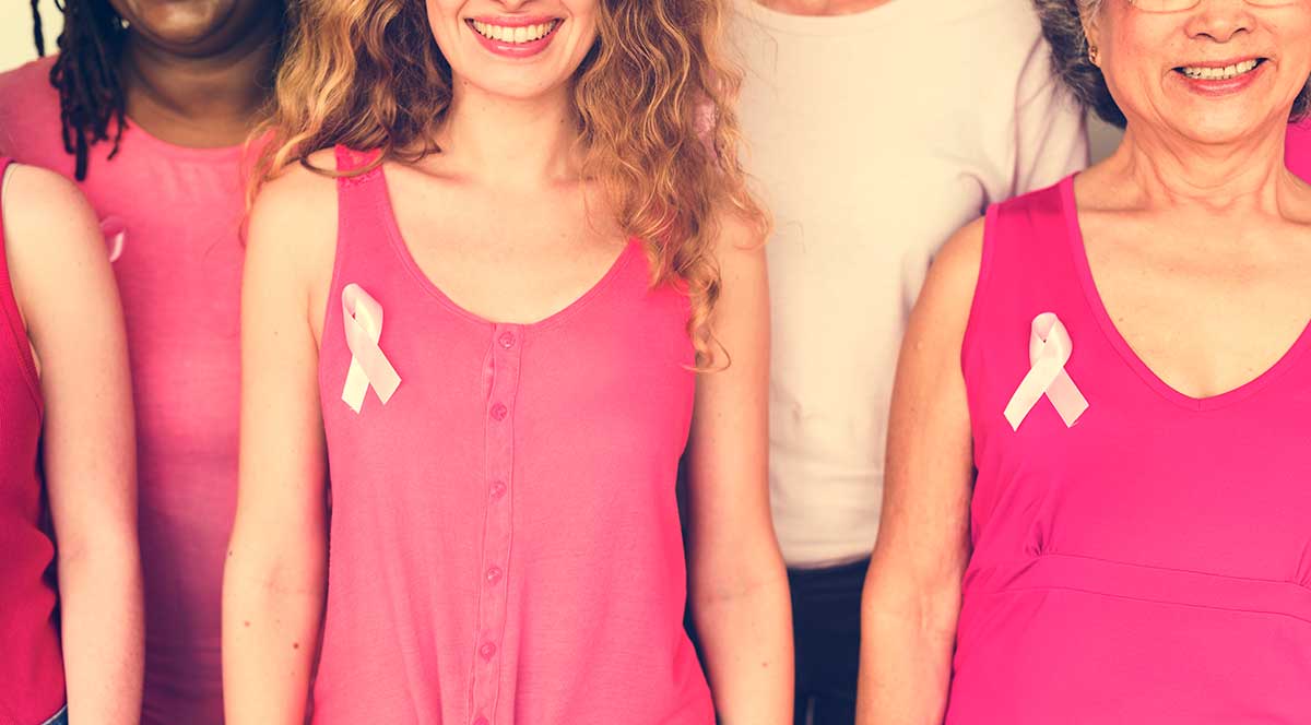 Women wearing pink and breast cancer ribbon
