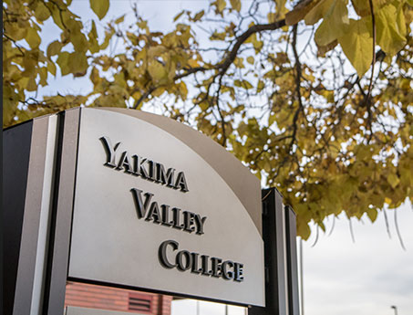 Yakima Valley College sign with tree