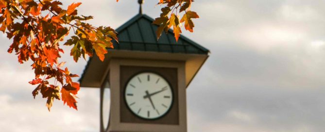 YVC's clocktower face with fall leaves