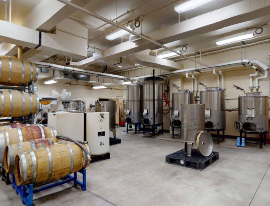 winery tank room with barrels and stainless tanks.