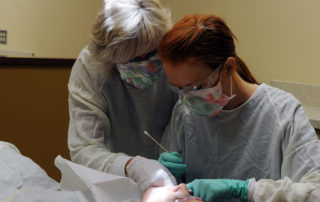 Pat Hakala helps a student in YVC's Dental lab
