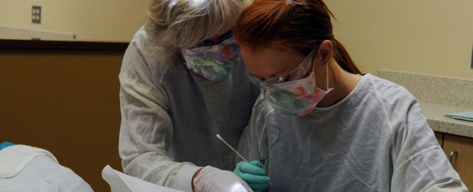 Pat Hakala helps a student in YVC's Dental lab