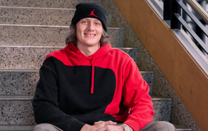Jacob Mclam poses for picture on the stairs inside one of the YVC buildings.