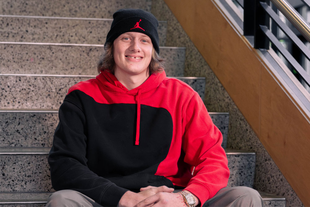 Jacob Mclam poses for picture on the stairs inside one of the YVC buildings.