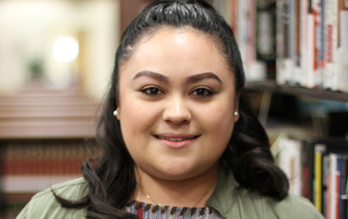 Gabriela Martinez poses for Student Story picture in the Library.
