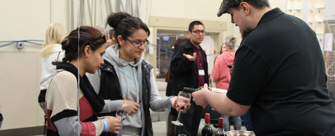 A student pours wine during the 2019 Teach, Tour & Taste event