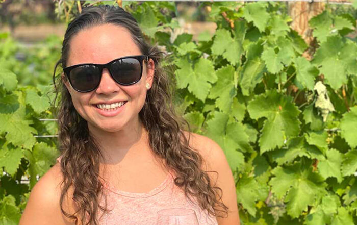Miriah Falce poses for Student Story picture in a local Vineyard.