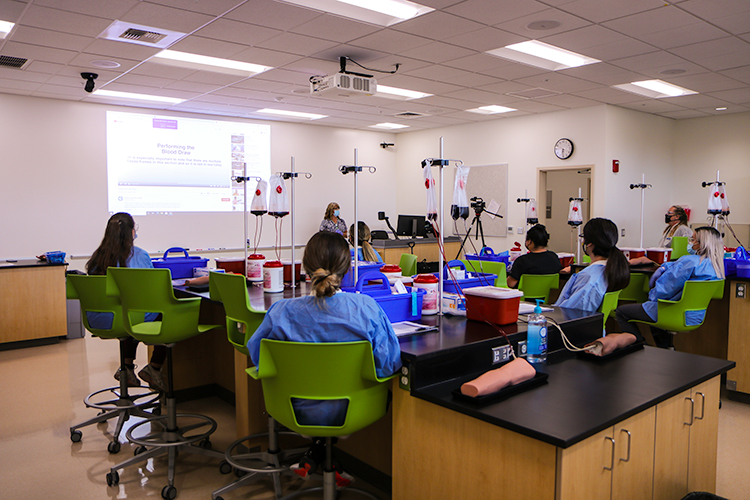 Professor lectures students in a Phlebotomy class.