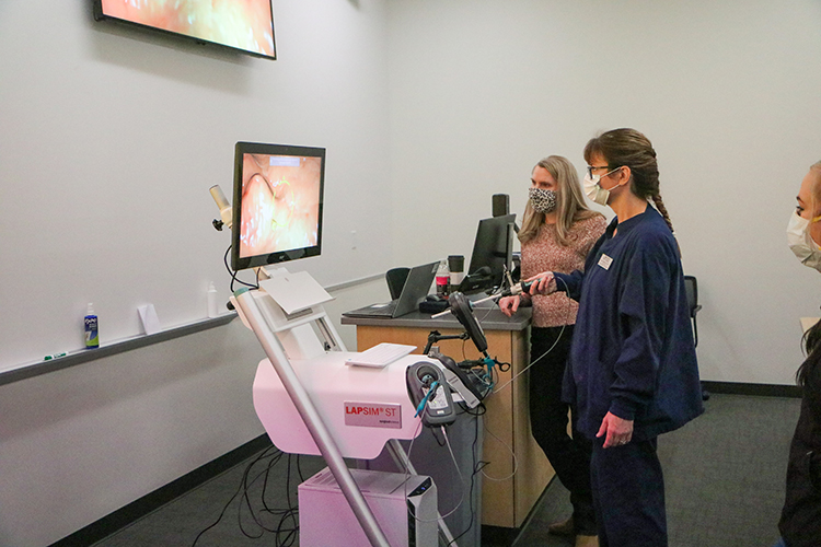 YVC Professor teaches student on the use of Surgical Tech Technology in a hands on exercise.